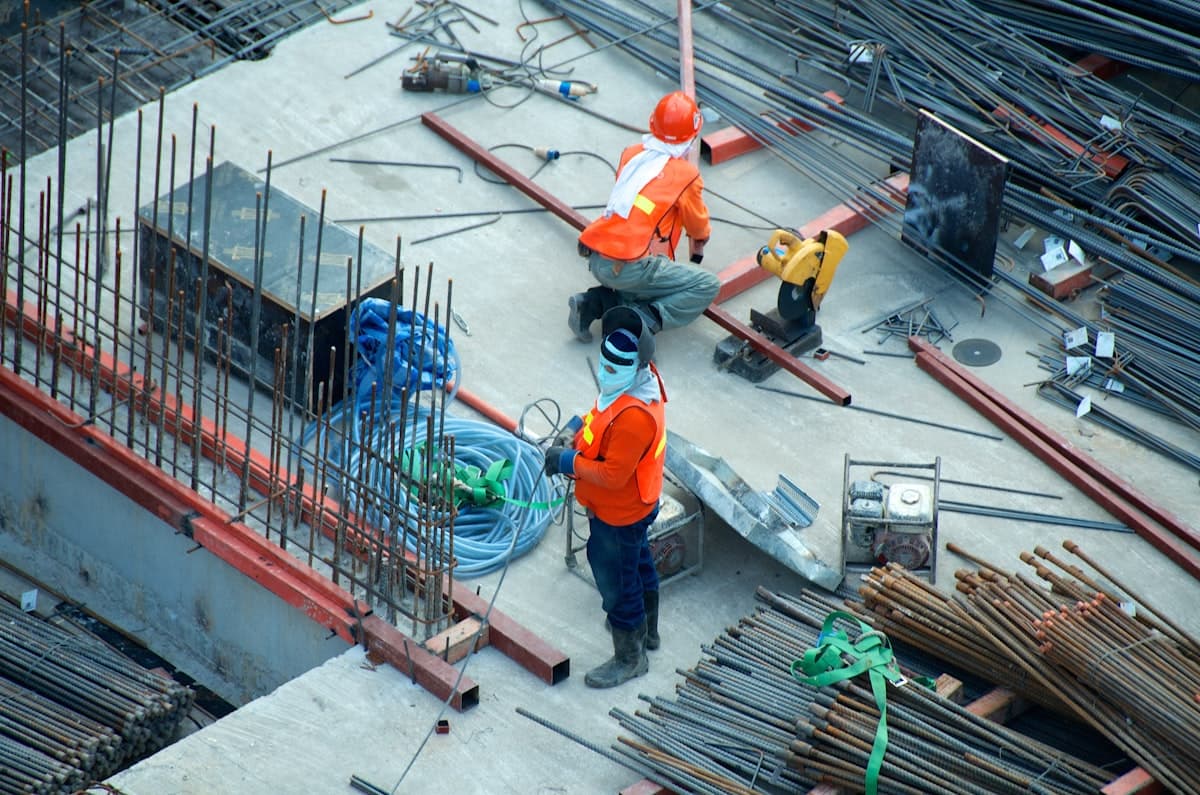 Contractor reviewing compliance documents on site
